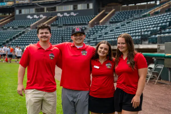 (Pictured in story photo, from left: Riley Dionne ’27, James Geehan ’26, Peyton Blackinton ’29 and Cate Marvin ’30 at Holman Stadium in Nashua, New Hampshire, over the summer.)