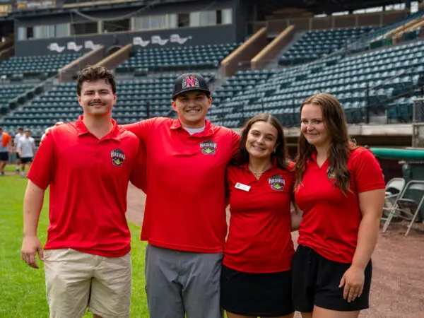 (Pictured in story photo, from left: Riley Dionne ’27, James Geehan ’26, Peyton Blackinton ’29 and Cate Marvin ’30 at Holman Stadium in Nashua, New Hampshire, over the summer.)