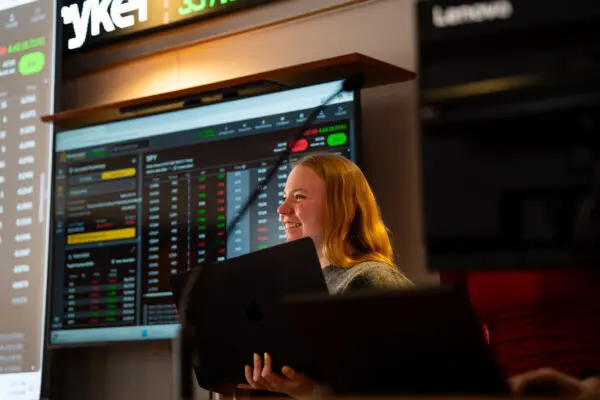 Photo of smiling student in the Bloomberg Finance Lab.