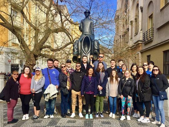 Students standing by the Franz Kafka statue in the Jewish Quarter
