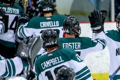 Nichols College Men's Hockey Captain high fiving his teammates