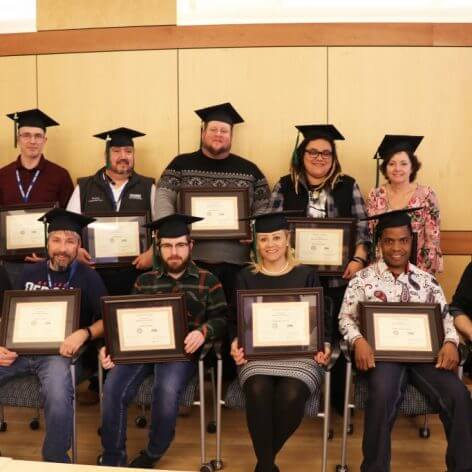 Students posing with their business certificate program certificates