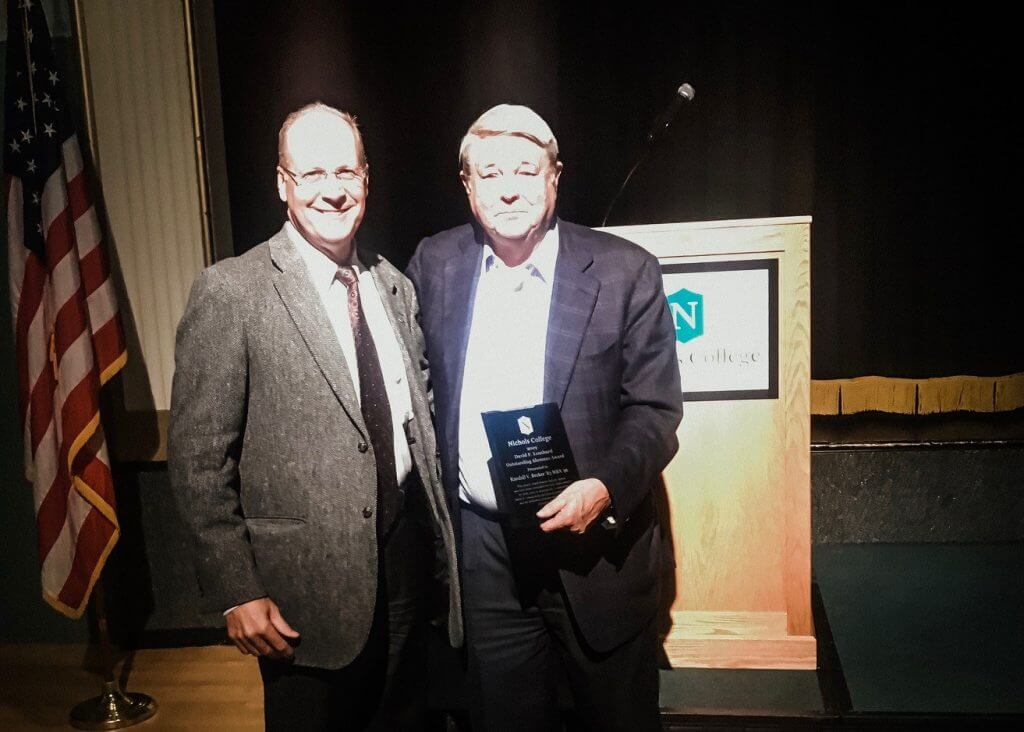 Randy Becker (left) accepts the David F. Lombard ’65 Outstanding Alumnus Award at Nichols College from the award’s namesake on October 18, 2019.