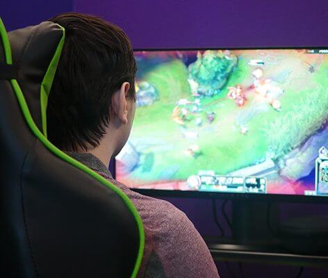 Student playing video games in Nichols College's new eSports room