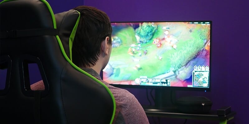 Student playing video games in Nichols College's new eSports room