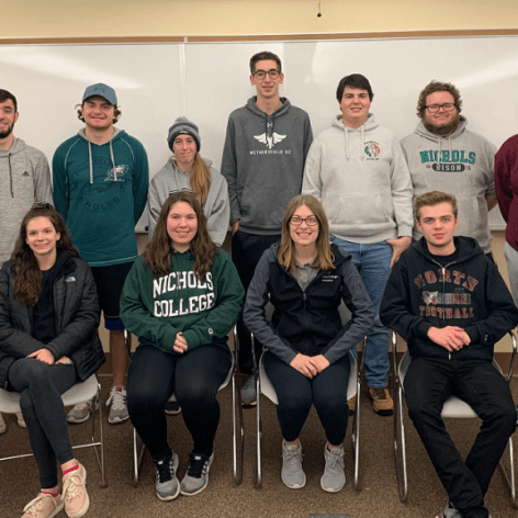 Nichols College students posing in two rows