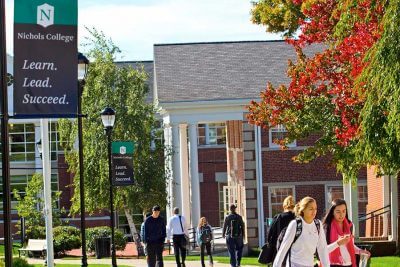 Students walking on campus by the Fels and Conant buildings