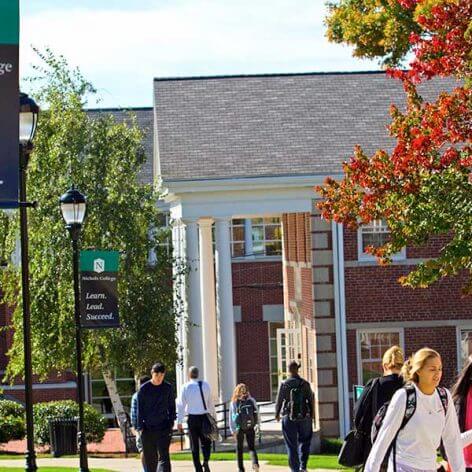 Students walking on campus by the Fels and Conant buildings