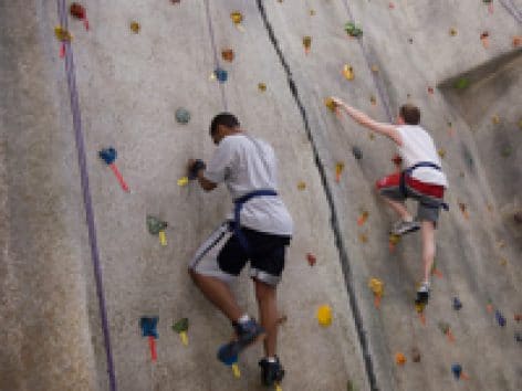 two students on a indoor climbing wall