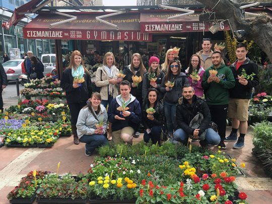 Students posing by flower shop in Thessaloniki, Greece.