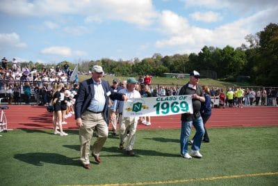 Alumni carrying Class of '69 banner