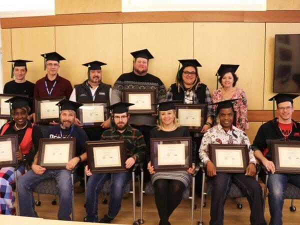 Students posing with their business certificate program certificates