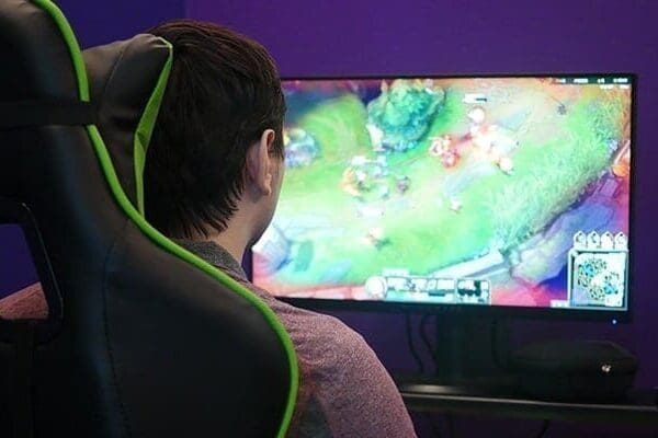 Student playing video games in Nichols College's new eSports room