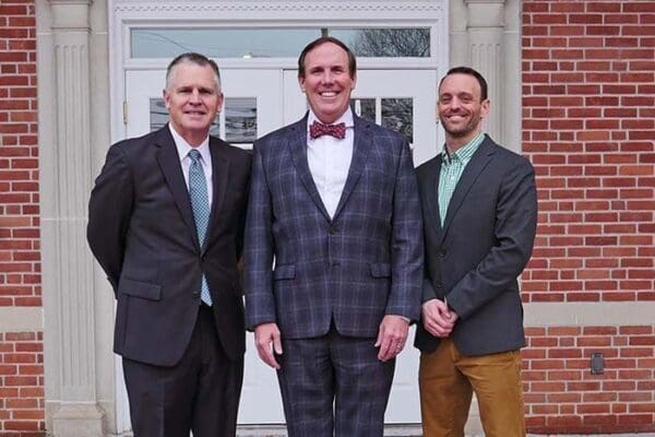 The Nichols College athletic leadership team, from left, Jack Hayes, Glenn Sulmasy, and Eric Gobiel.