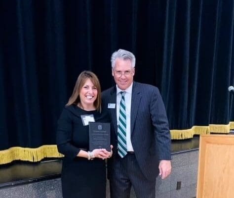 Newport Hospital President Crista Durand receives the Nichols College Alumni Achievement Award from Bill Pieczynski, vice president for advancement at Nichols, on October 15.