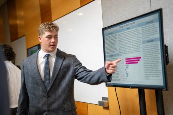 A student presenting at the REAL Symposium.