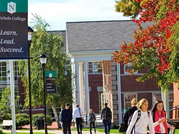 Students walking on campus by the Fels and Conant buildings