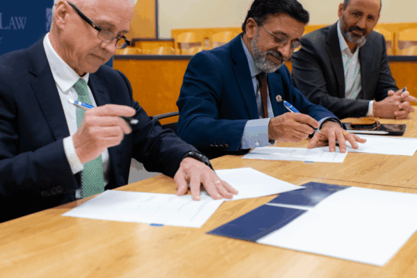 Nichols College Provost Daniel J. Borgia, joined by UMass Dartmouth Interim Provost/Vice Chancellor Ramprasad Balasubramanian and UMass Law Dean Sam Panarella, sign an agreement to establish a 3+3 accelerated degree program with Nichols College that will enable students to earn a bachelor’s and law degree in six rather than seven years
