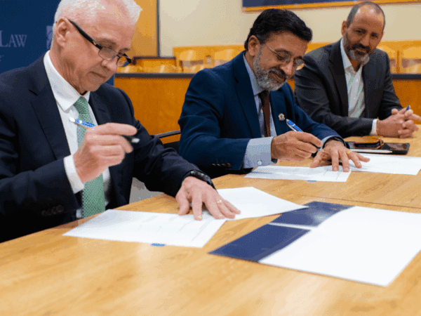 Nichols College Provost Daniel J. Borgia, joined by UMass Dartmouth Interim Provost/Vice Chancellor Ramprasad Balasubramanian and UMass Law Dean Sam Panarella, sign an agreement to establish a 3+3 accelerated degree program with Nichols College that will enable students to earn a bachelor’s and law degree in six rather than seven years