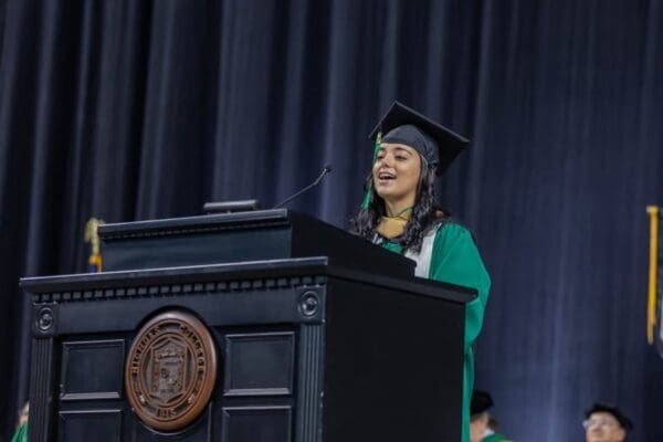 Senior Class President Ingrid de Souza Oliveira delivers remarks during the Nichols College 2024 commencement ceremony held at the DCU Center in Worcester, Mass