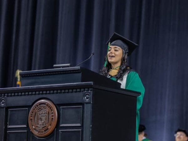Senior Class President Ingrid de Souza Oliveira delivers remarks during the Nichols College 2024 commencement ceremony held at the DCU Center in Worcester, Mass