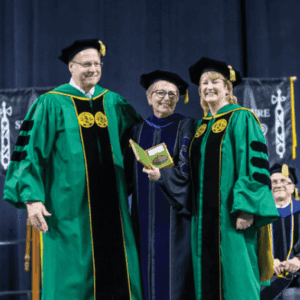 Dr. Susan West Engelkemeyer (middle) accepting her medallions