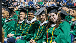 Nichols College graduates smile for the camera at the DCU Center on May 2.
