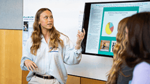 McKenzie Guertin ’27 presents her psychology research project during the REAL Symposium.