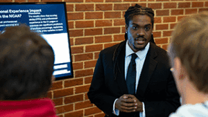 Nasir Bridgewater ’26, recently hired by the Atlanta Hawks through its Sales Development Program, presents his research project.