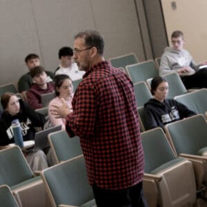 A Nichol College professor presenting to a room of students on their Dudley, MA campus.