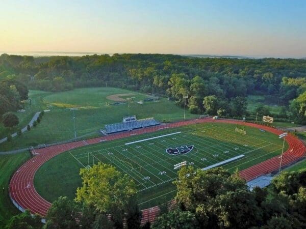 An aerial view of Vendetti Field at Nichols College at sunrise with rolling New England Hills in the background