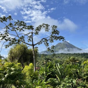 Arenal Volcano in Costa Rica viewed from a distance with dense jungle growth in between.