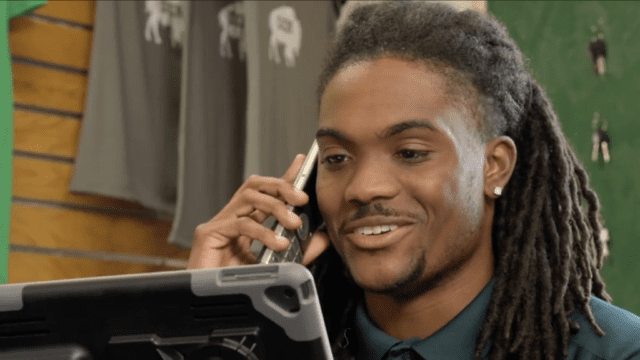A Nichols College student answers the phone while working at The Bison Den and Grill